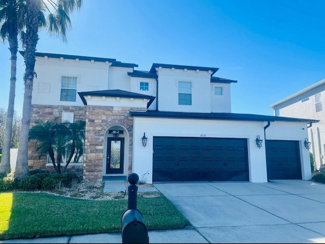 view of front of property featuring stone siding, driveway, and stucco siding