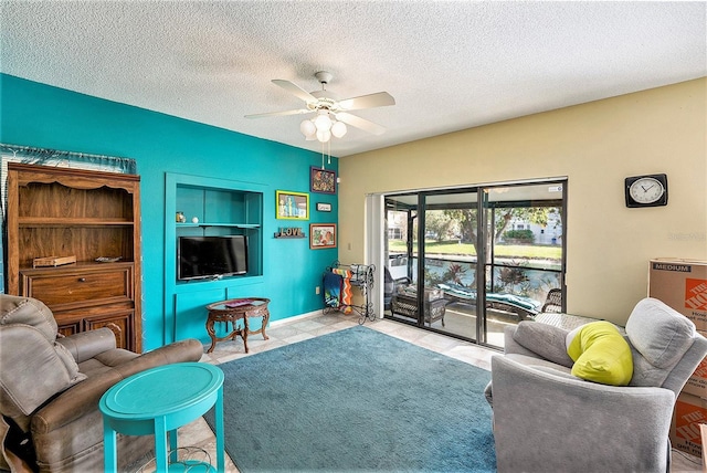 tiled living room featuring a textured ceiling and ceiling fan