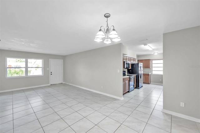 interior space featuring an inviting chandelier and light tile patterned floors