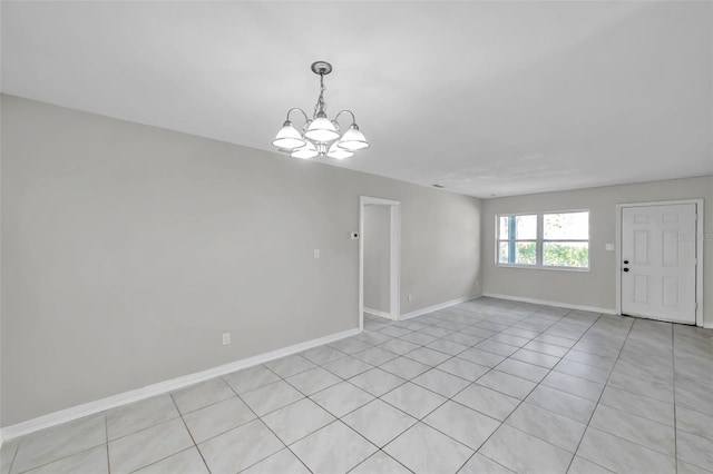 unfurnished room featuring an inviting chandelier