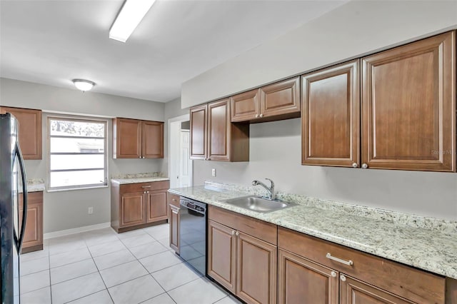 kitchen with sink, black appliances, light tile patterned flooring, and light stone counters