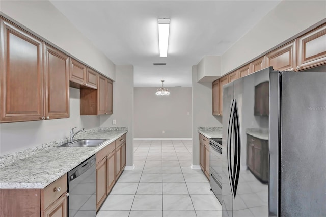 kitchen with appliances with stainless steel finishes, pendant lighting, light tile patterned floors, sink, and an inviting chandelier