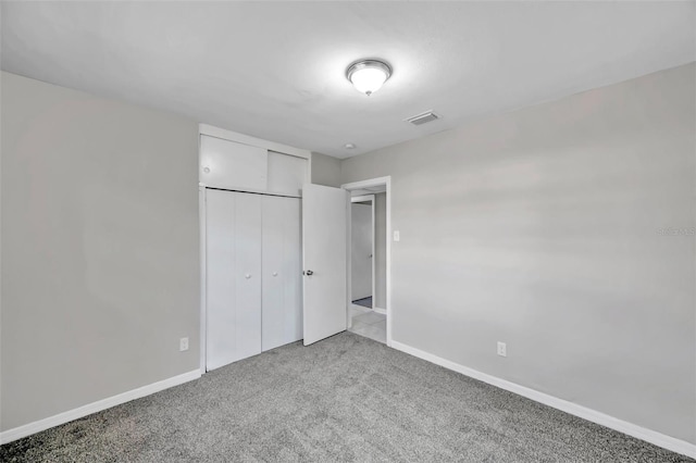 unfurnished bedroom with carpet and a closet