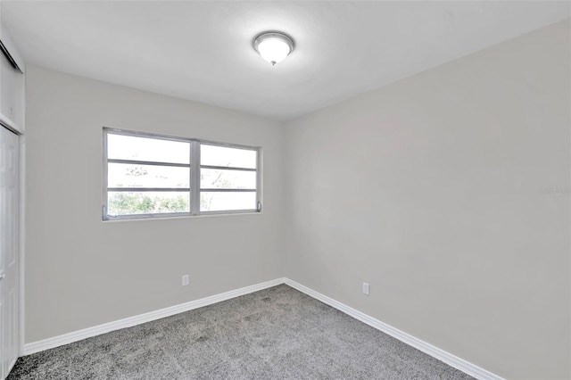 unfurnished bedroom featuring carpet and a closet