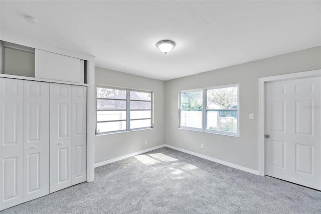 unfurnished bedroom with light carpet and a closet