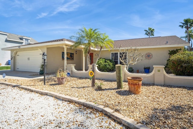 ranch-style home with driveway, an attached garage, and stucco siding