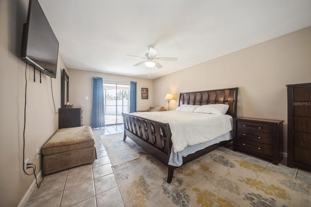 bedroom with access to exterior, light tile patterned floors, and a ceiling fan