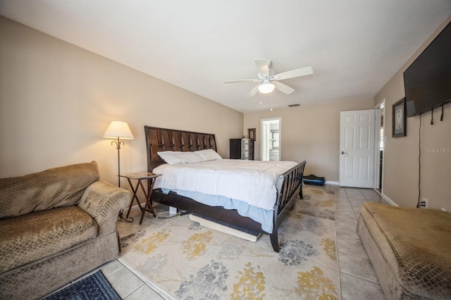 bedroom with light tile patterned floors, vaulted ceiling, a ceiling fan, and baseboards