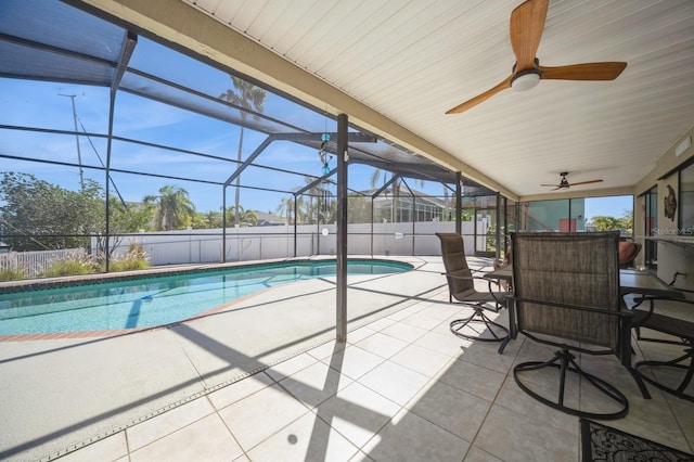 view of swimming pool with a fenced in pool, glass enclosure, a patio, and ceiling fan