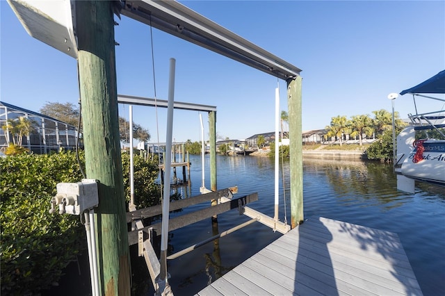 dock area with a water view and boat lift