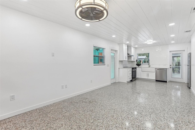 kitchen with recessed lighting, light countertops, appliances with stainless steel finishes, white cabinets, and speckled floor