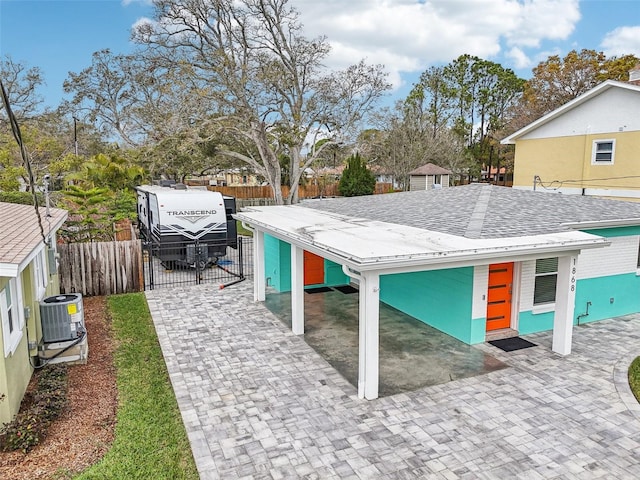 exterior space featuring fence and central AC unit