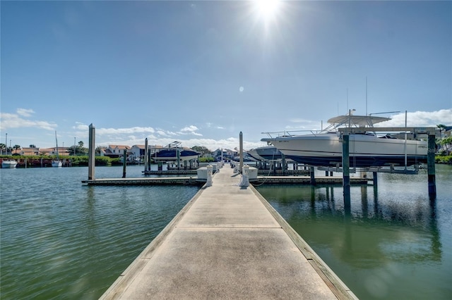 dock area featuring boat lift and a water view