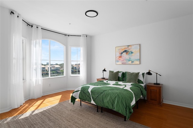 bedroom with wood finished floors and baseboards