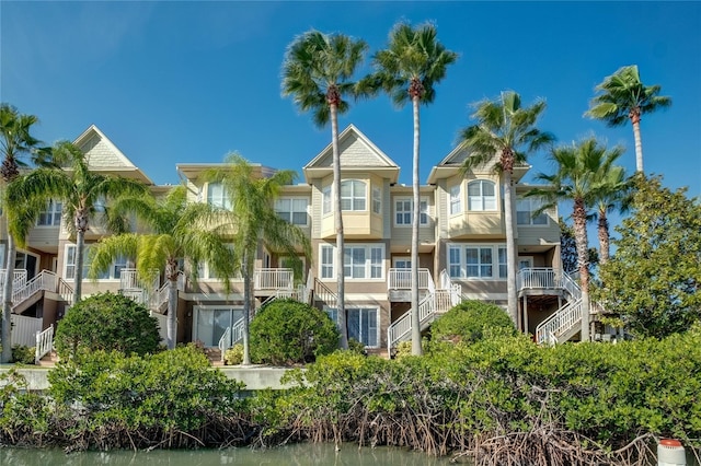 view of property with a water view and stairway