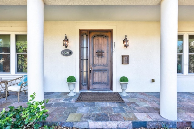 property entrance featuring stucco siding