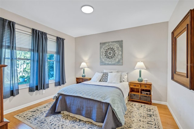 bedroom featuring baseboards and wood finished floors