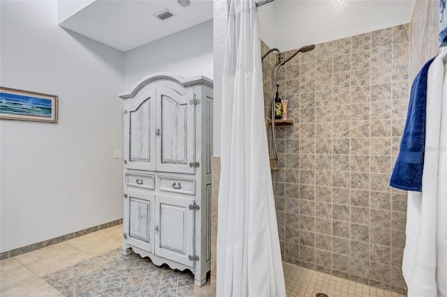 full bathroom with tile patterned floors, a shower stall, visible vents, and baseboards