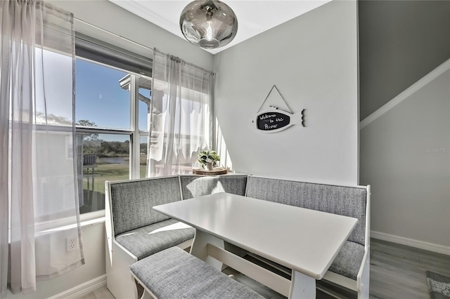 dining room featuring breakfast area and wood-type flooring