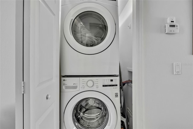 laundry area featuring stacked washer and clothes dryer