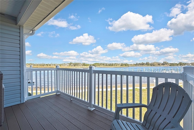 wooden terrace featuring a yard and a water view