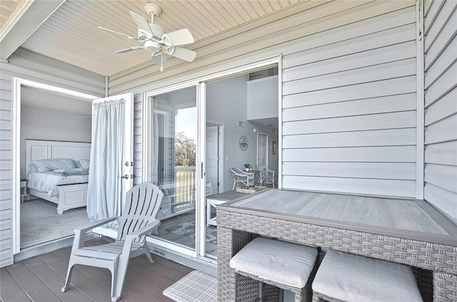 sunroom featuring ceiling fan