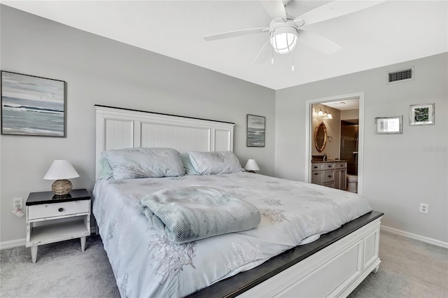 bedroom featuring ensuite bathroom, ceiling fan, and light colored carpet