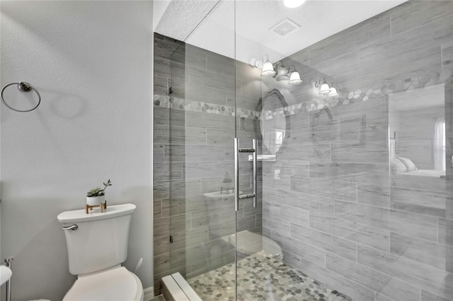 bathroom with an enclosed shower and toilet