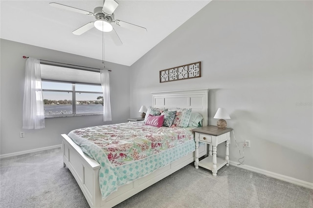 bedroom featuring ceiling fan, vaulted ceiling, and light carpet