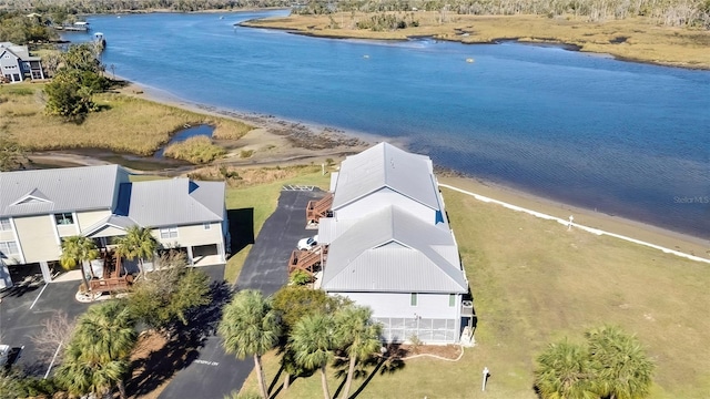 drone / aerial view featuring a water view and a view of the beach