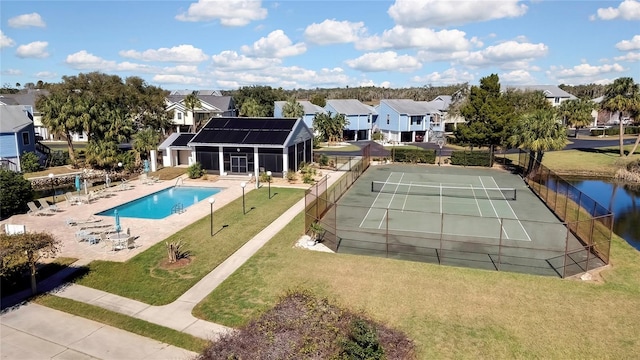 view of swimming pool featuring tennis court and a yard