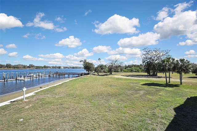 view of dock featuring a yard and a water view