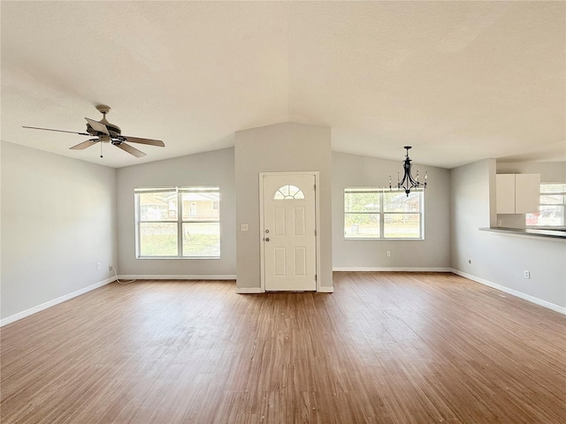 entryway with light wood-type flooring, plenty of natural light, and lofted ceiling