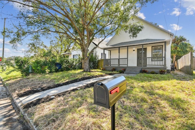 view of front of home featuring covered porch and a front yard