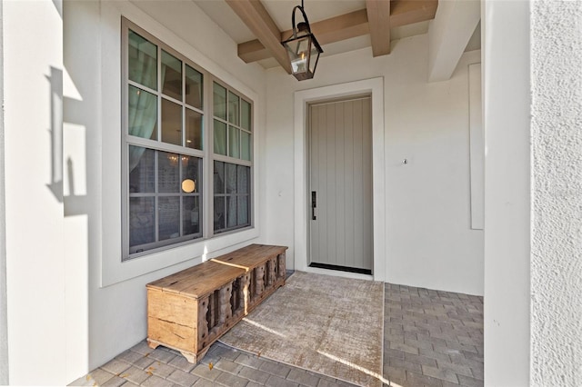 property entrance featuring a patio and stucco siding