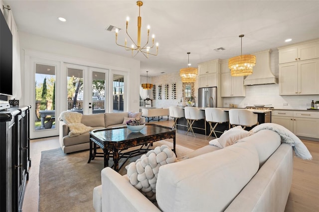 living area featuring visible vents, french doors, a notable chandelier, and recessed lighting