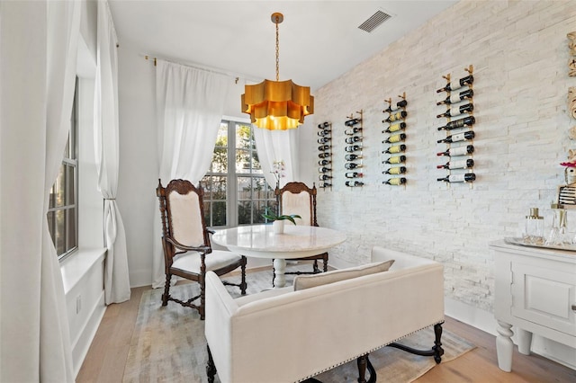 dining room featuring light wood-type flooring and visible vents