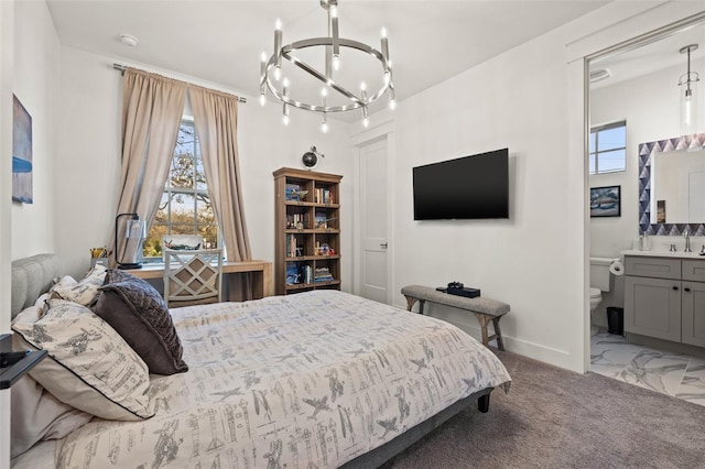 bedroom with connected bathroom, a sink, baseboards, marble finish floor, and an inviting chandelier