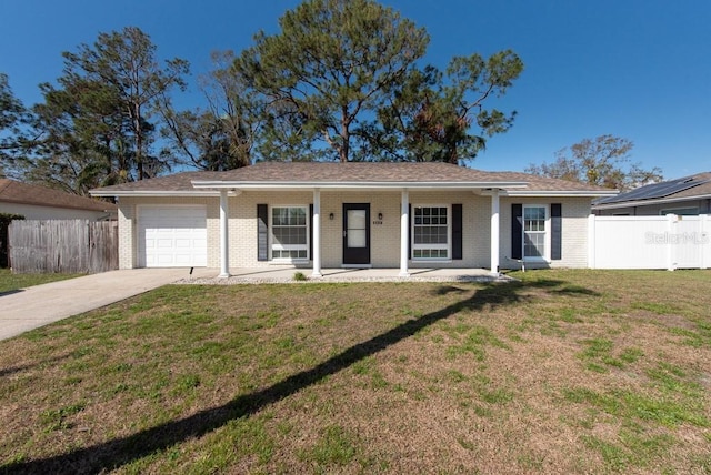 ranch-style home with a front yard, a garage, and a porch