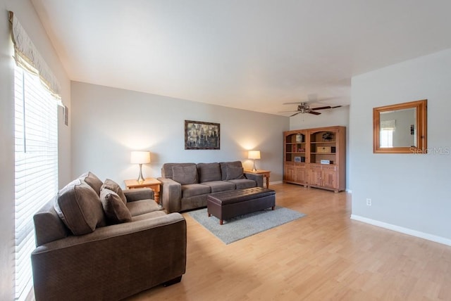 living room featuring ceiling fan and light hardwood / wood-style flooring