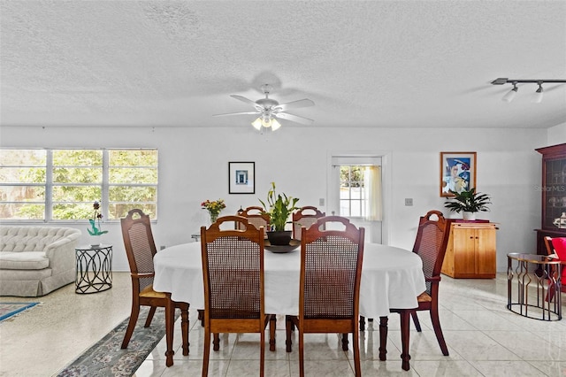 dining room with a textured ceiling and ceiling fan