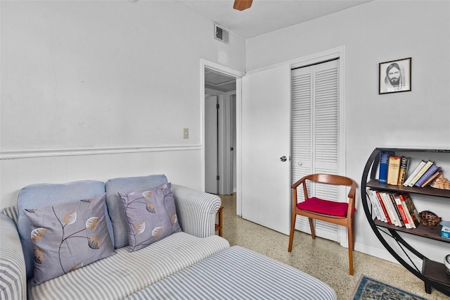 bedroom featuring ceiling fan, visible vents, a closet, and speckled floor