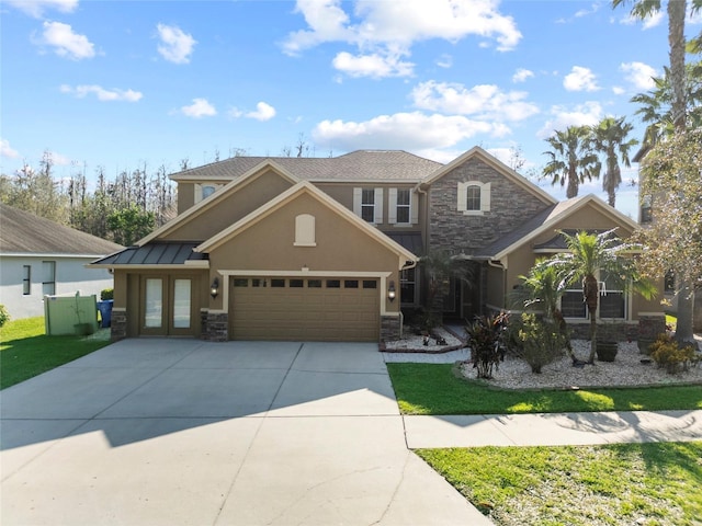 view of front of property featuring stone siding, an attached garage, concrete driveway, and stucco siding