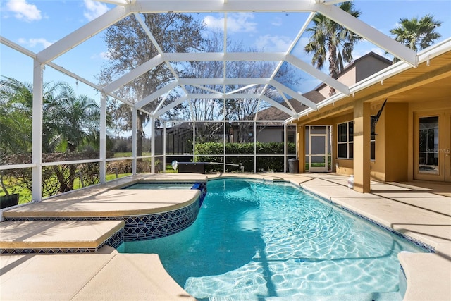 outdoor pool featuring a lanai and a patio area