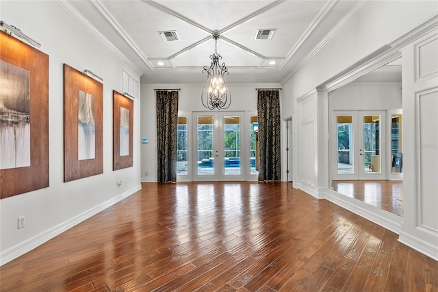 empty room with french doors, visible vents, and wood finished floors