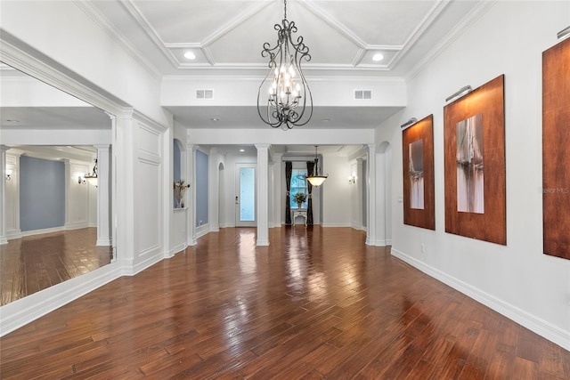 interior space with decorative columns, visible vents, and wood finished floors