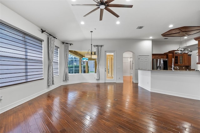 unfurnished living room featuring arched walkways, recessed lighting, visible vents, a ceiling fan, and hardwood / wood-style floors