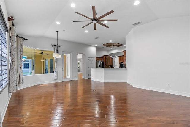 unfurnished living room featuring a ceiling fan, arched walkways, vaulted ceiling, and dark wood-style floors