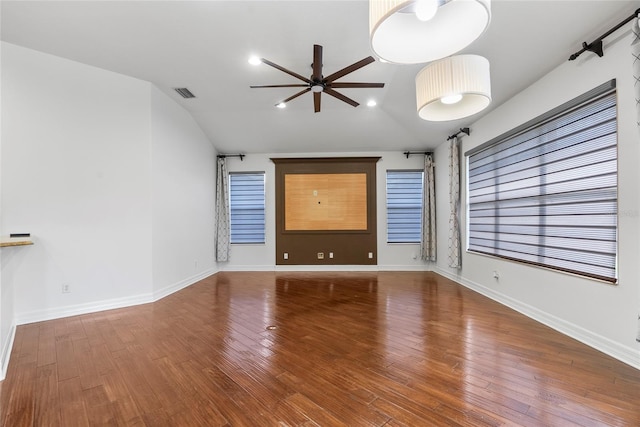 unfurnished living room with baseboards, visible vents, lofted ceiling, ceiling fan, and wood finished floors