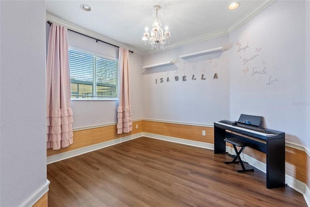 office with a wainscoted wall, a notable chandelier, ornamental molding, wood finished floors, and baseboards